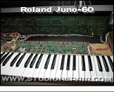 Roland Juno-60 - Opened * Case opened - view onto the main board and mainly the right one of the two panel boards. The yellow cylinder on the right is the CR-1/3-N lithium backup battery soldered onto the PCB.